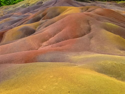 Close up of colored Seven Earths of Chamarel, a geological phenomenon created by volcanic activity and different cooling times. Mauritius, Indian Ocean. Bucket List