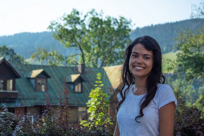 Bruna standing in front of a house