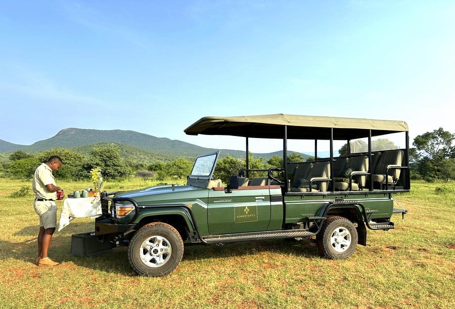 Kingfisher Villa Game vehicle with game ranger setting the table