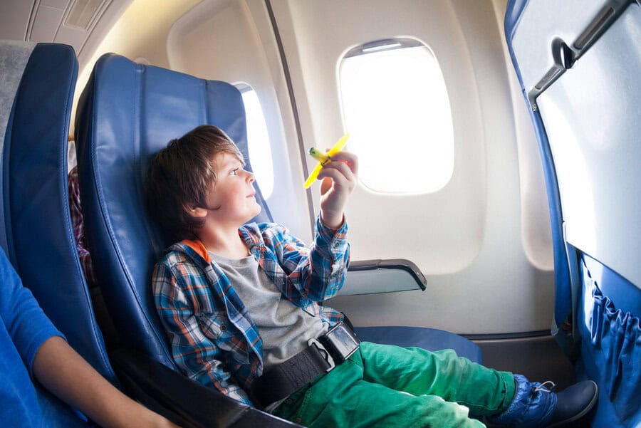 Child sitting at airplane window