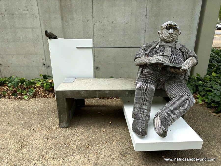 Metal Sculpture of man sitting on a bench